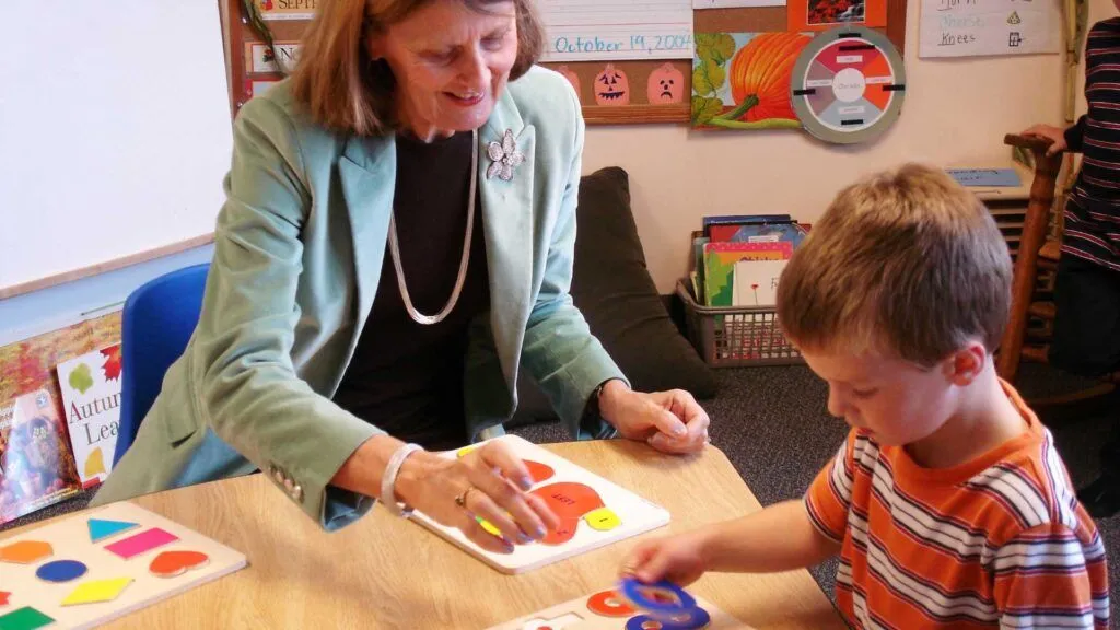 Blanche Podhajski, Stern Center President Emerita, works with a student.