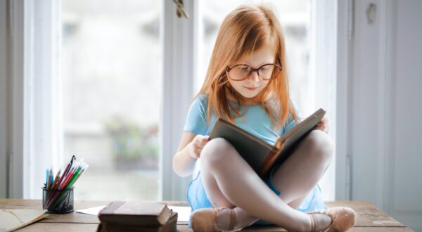 Young girl with glasses reading