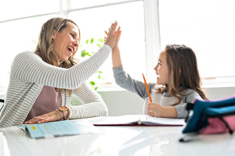mom giving a high-five to daughter
