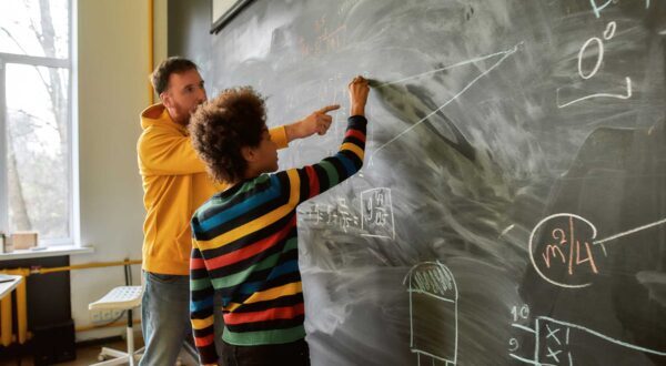 Math teacher and student at chaulk board