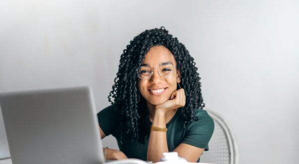 Smiling woman at computer desk