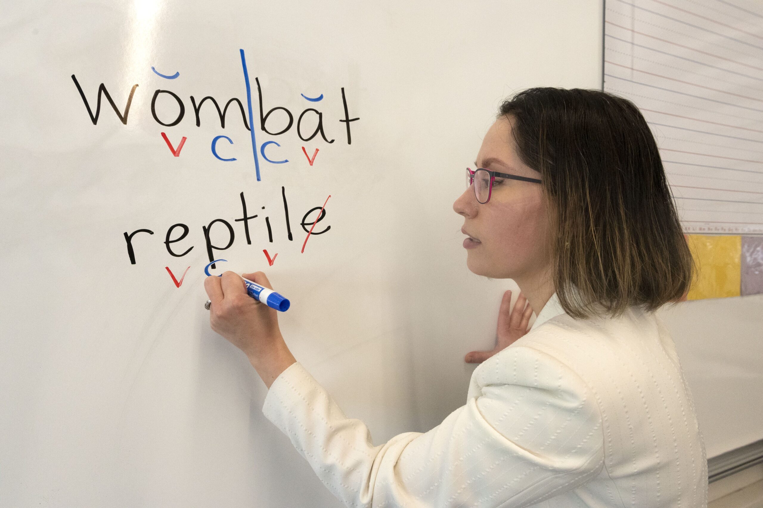 Peggy Price at white board writing