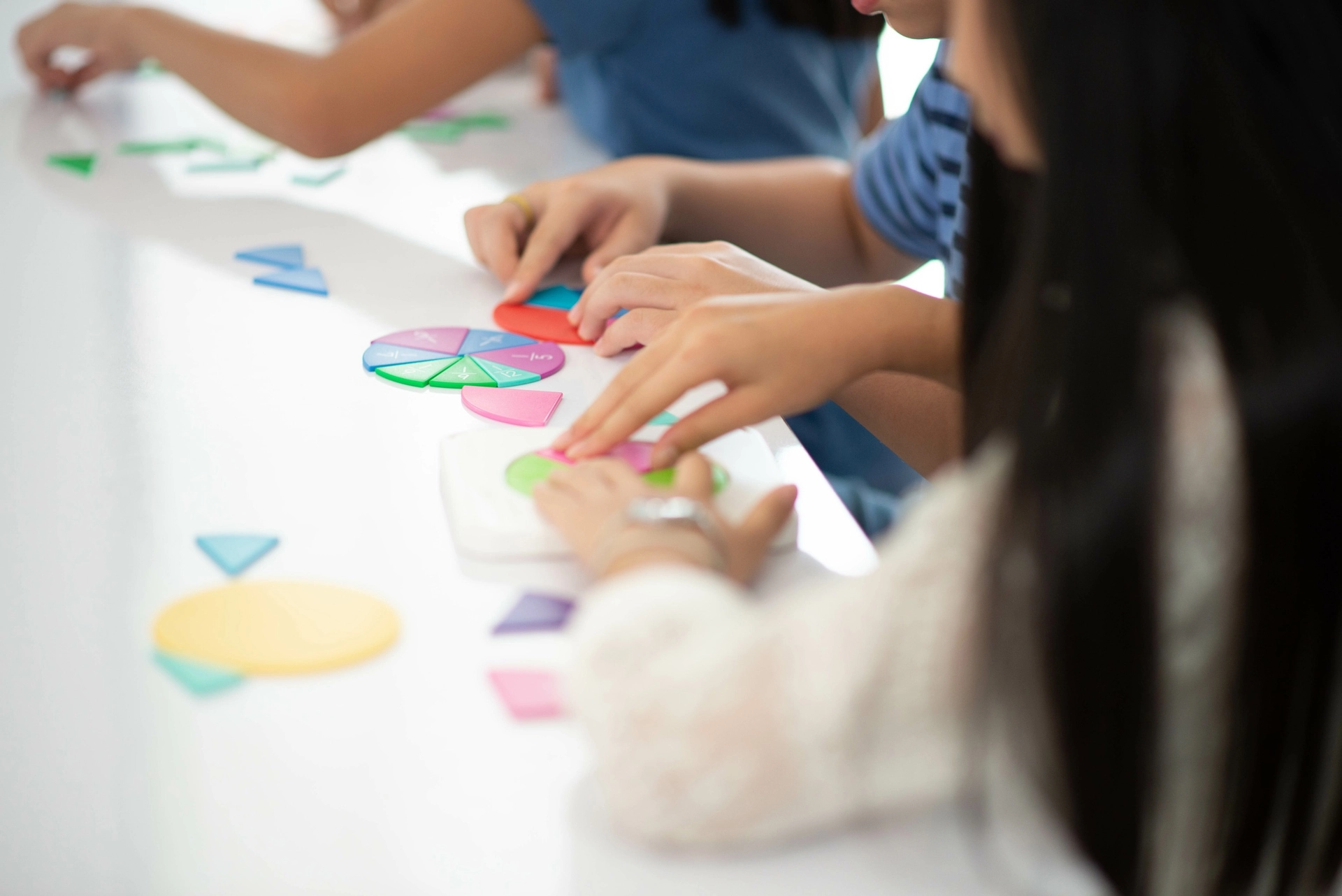 A teacher and students’ hands using manipulatives as part of math instruction