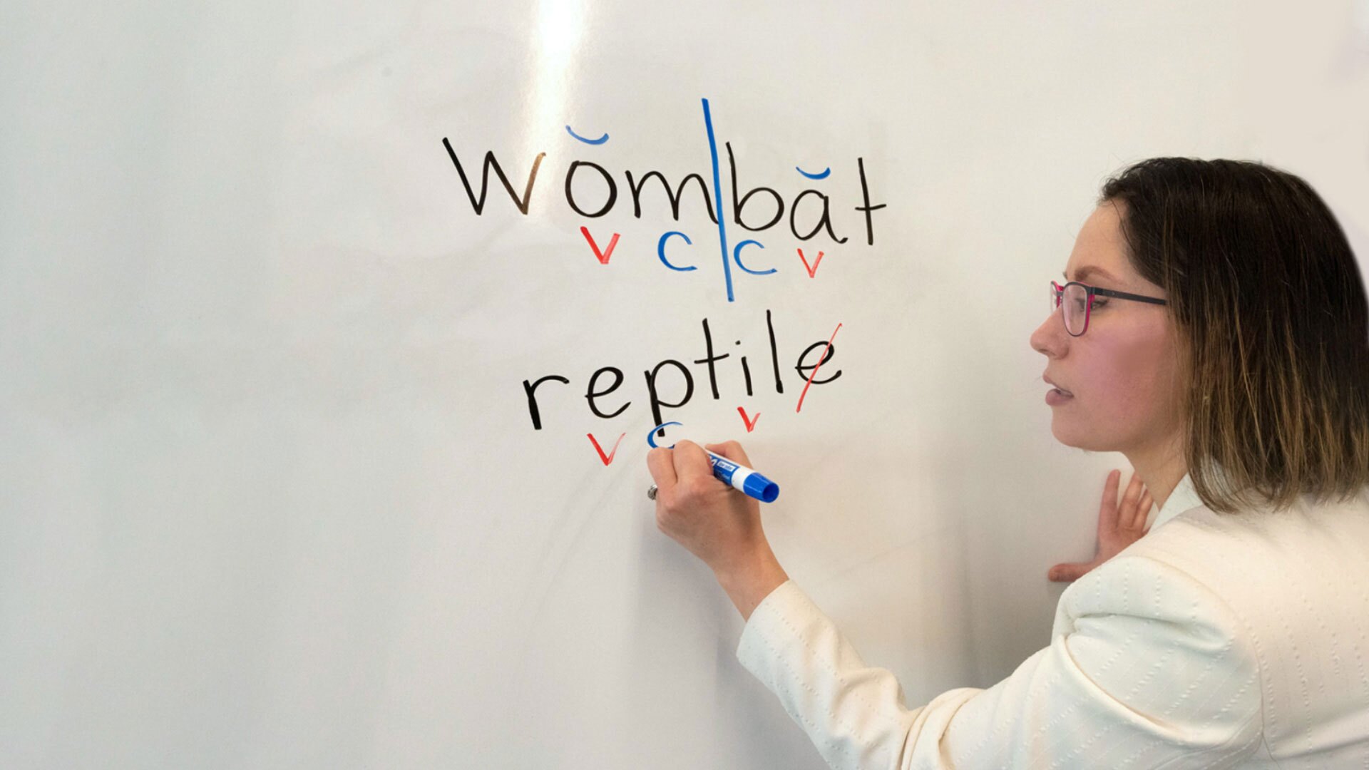 Orton-Gillingham Institute Director Peggy Price writes on a whiteboard
