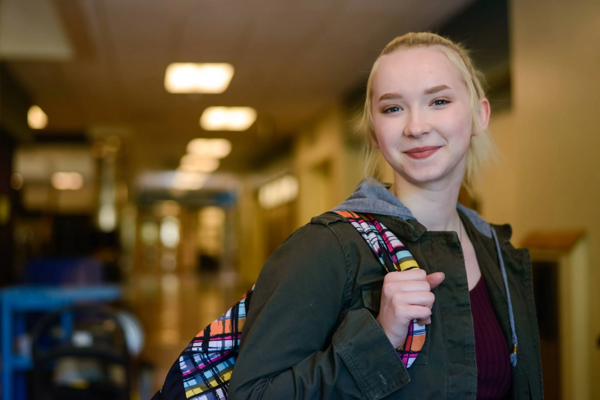 Smiling teenage girl in school hallway