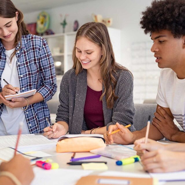 A group of high school students working together on a class project