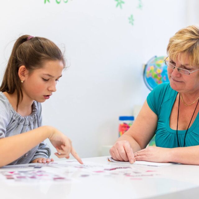 Female teacher working with middle school girl student