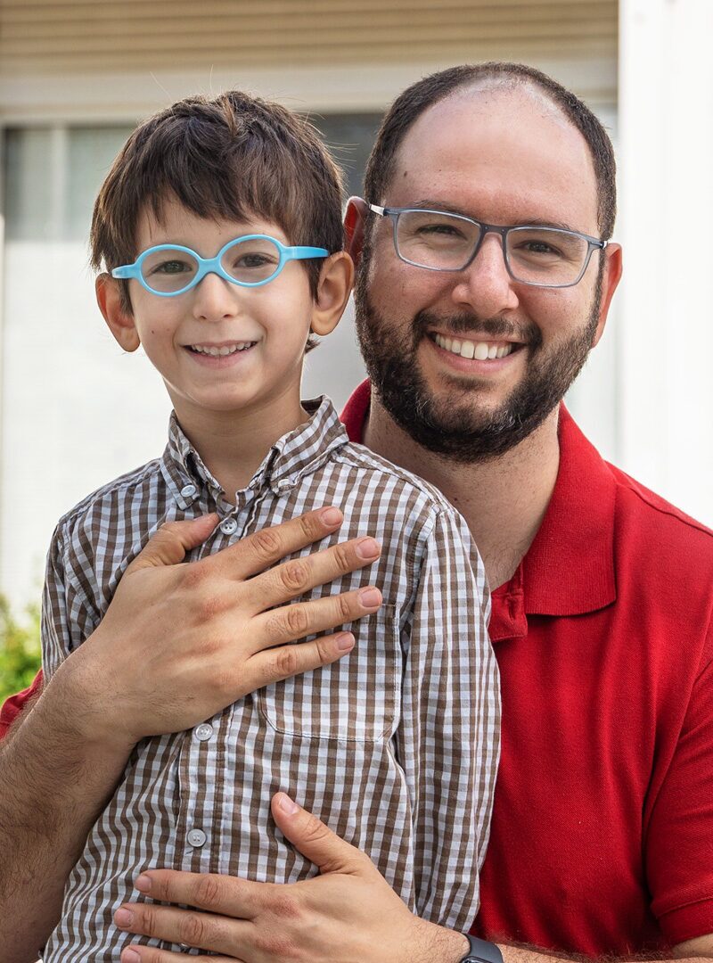 A father and his son, who is a Stern Center student, stand outside of the Stern Center building