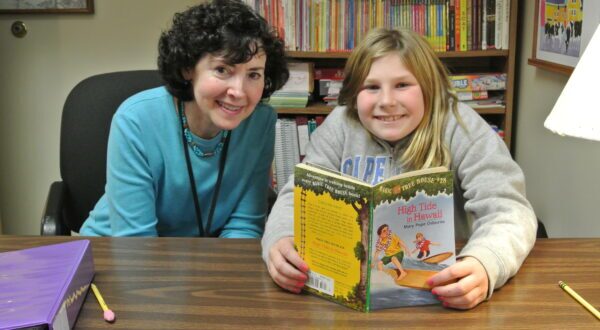 Smiling teacher with student