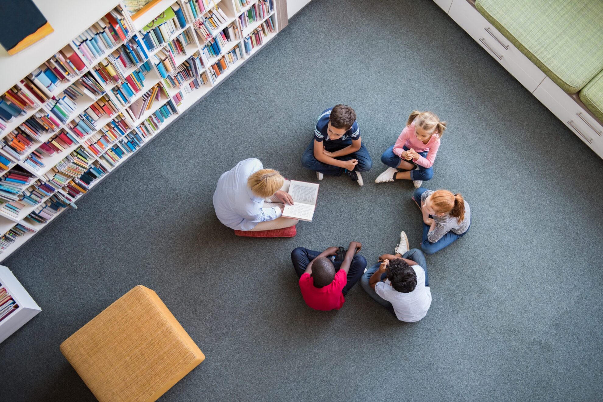kids in library on the floor in a circle