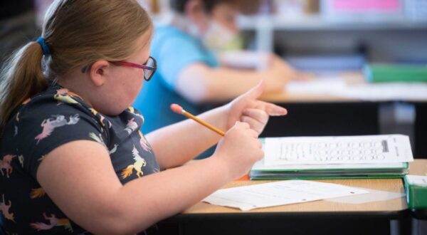 Young girl student counting using her fingers