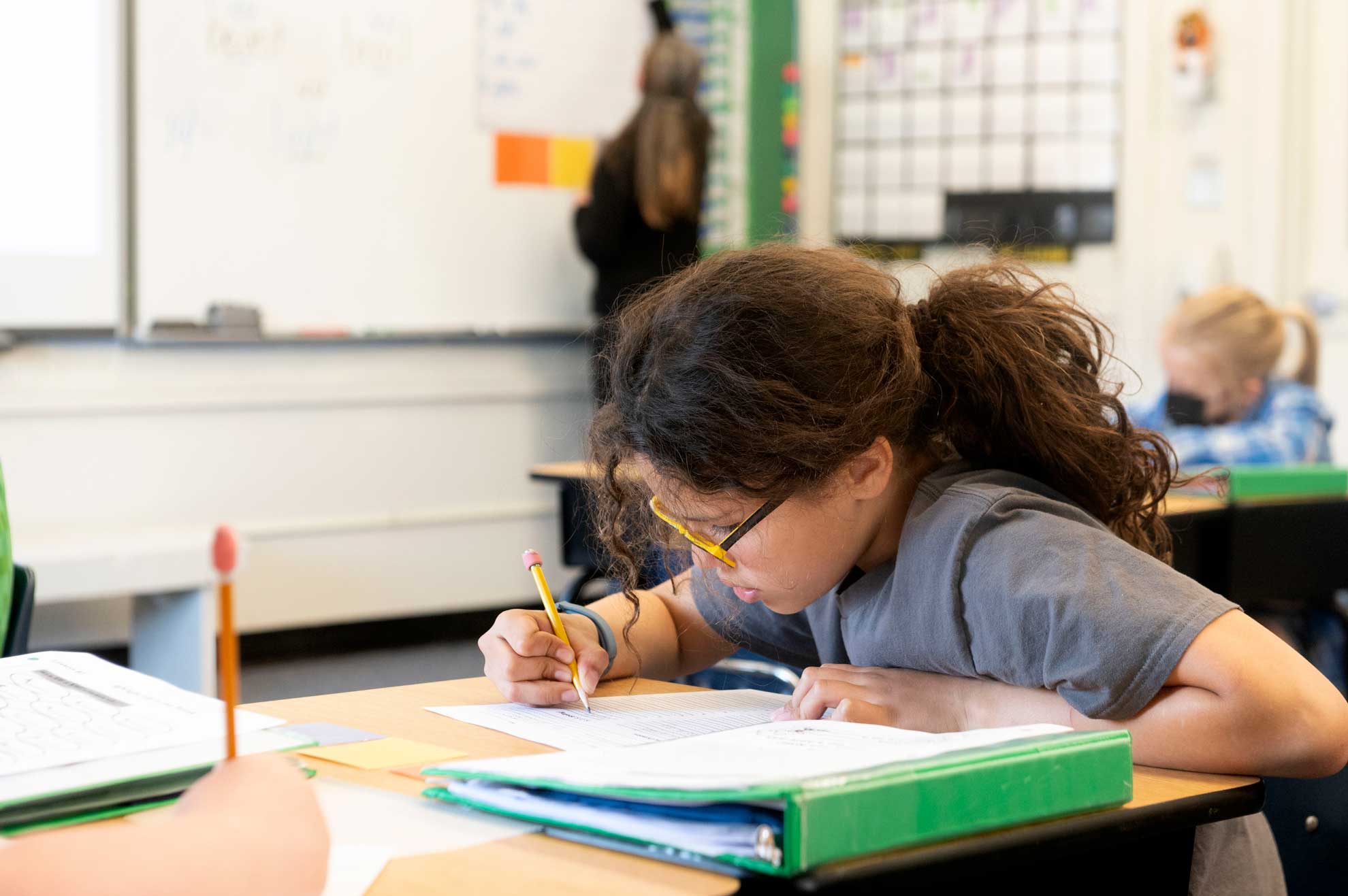 Girl at desk writing