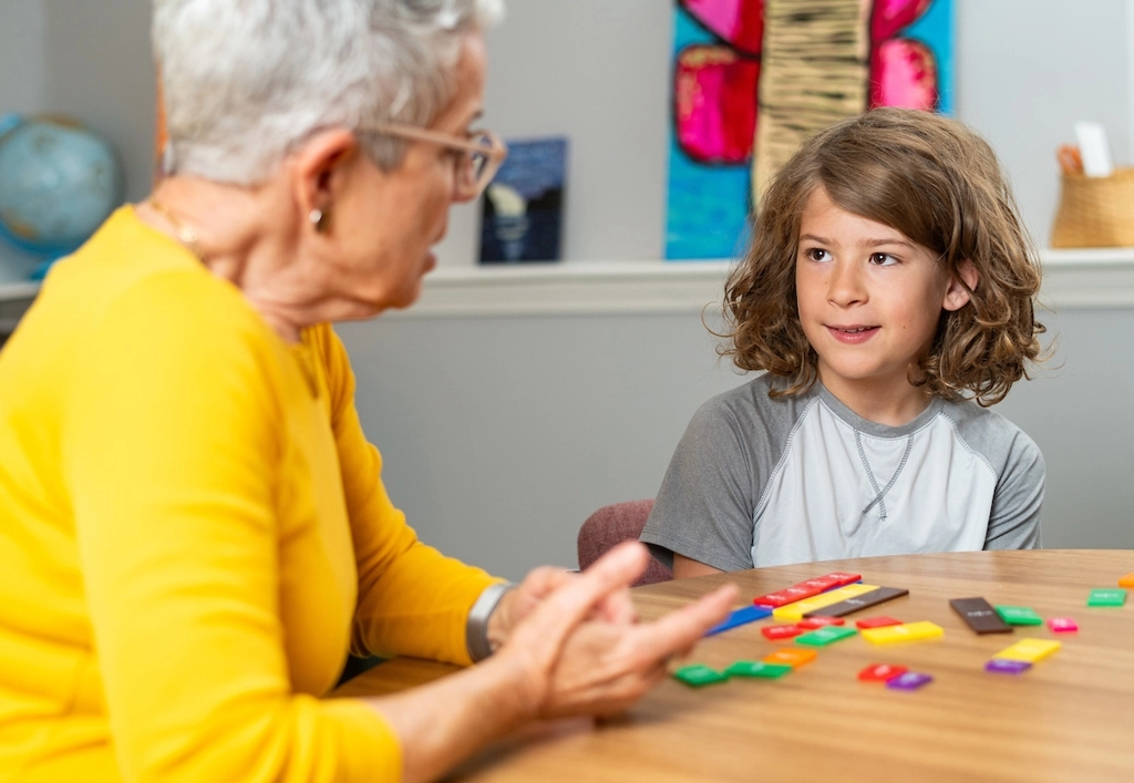 An instructor teaches a multisensory math lesson to a student