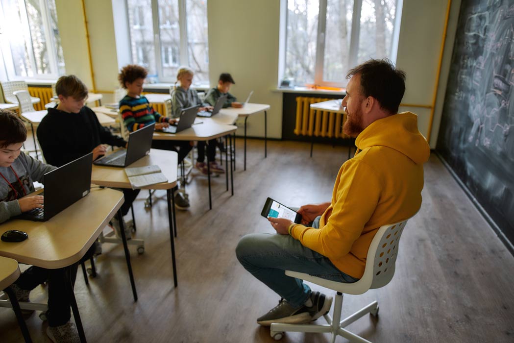male teahcer speaking with class