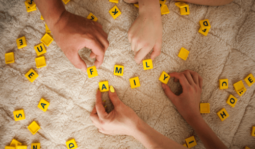 hands playing scrabble
