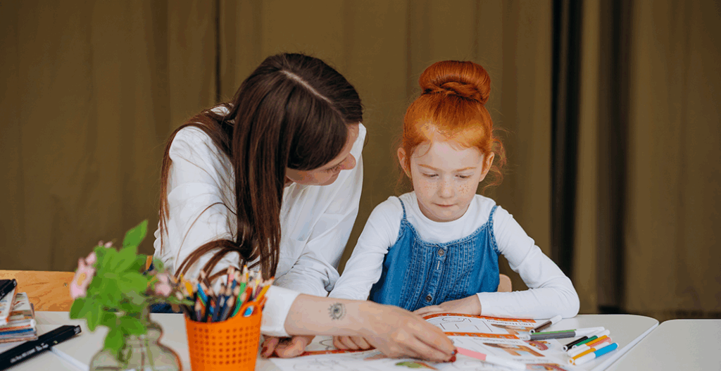 teacher with young girl studnet