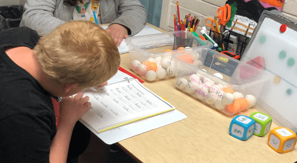 boy-student-working-in-workbook