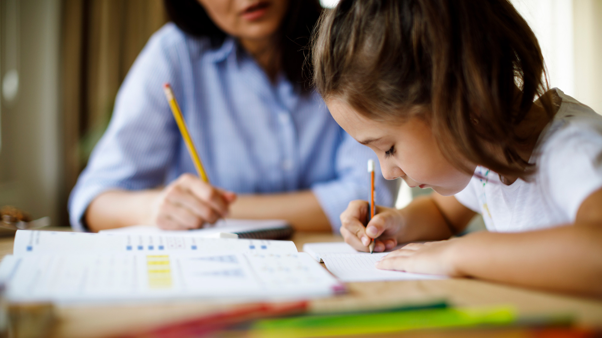 A child psychologist conducts a learning evaluation with a student.