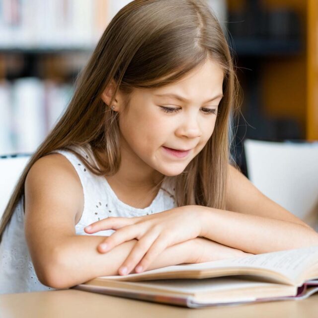 Young student reading a book
