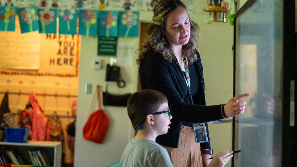 teacher-at-board-with-student