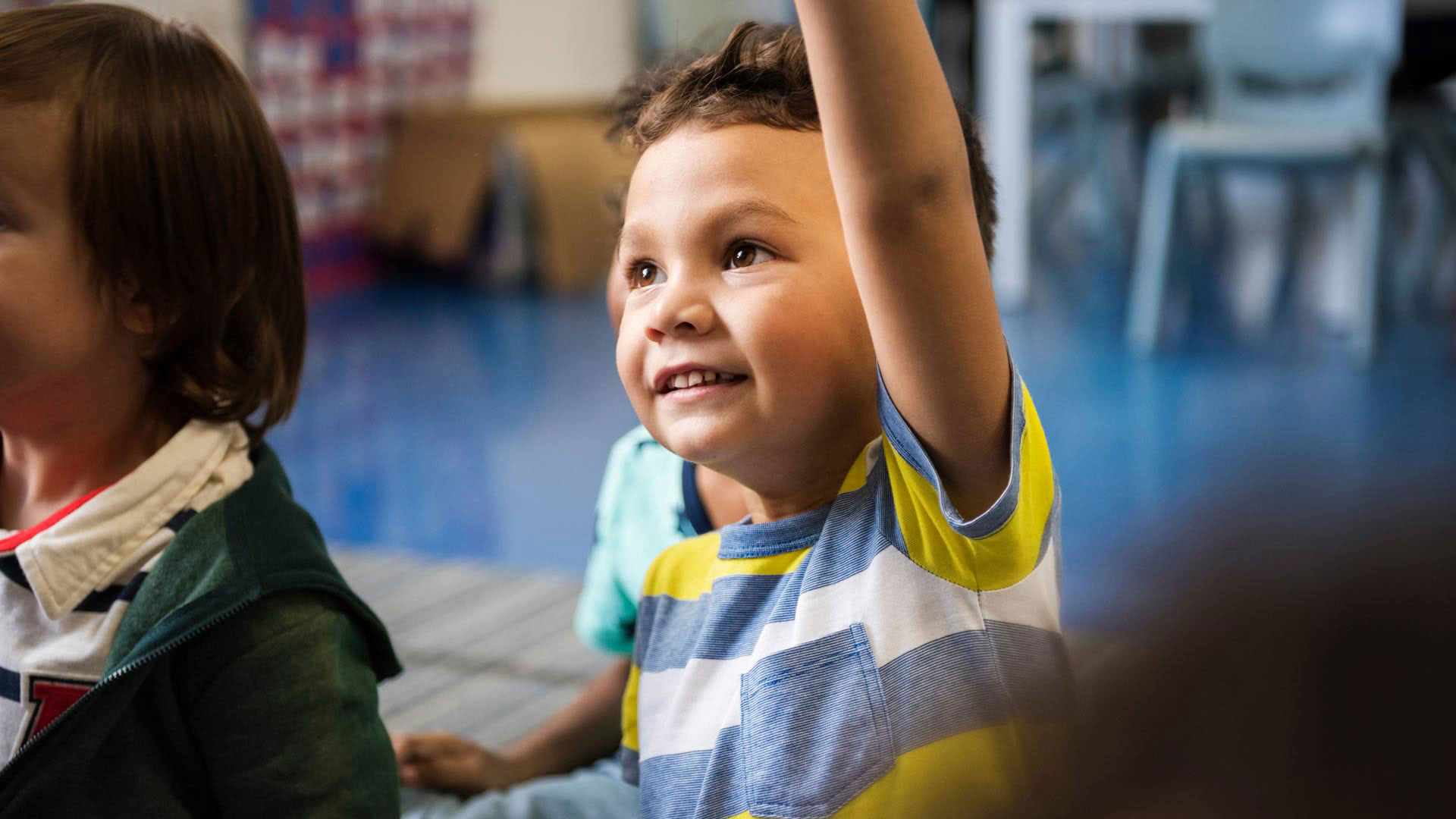 Elementary student raising his hand