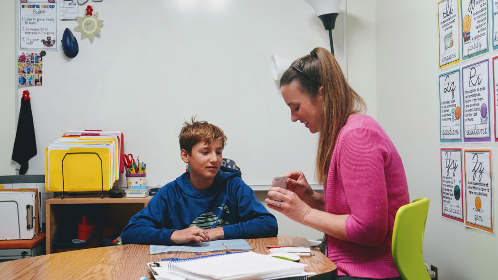 A special educator works on a phonogram drill with a student at school.