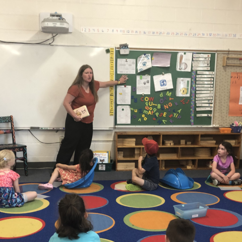 Teacher at white board teaching students