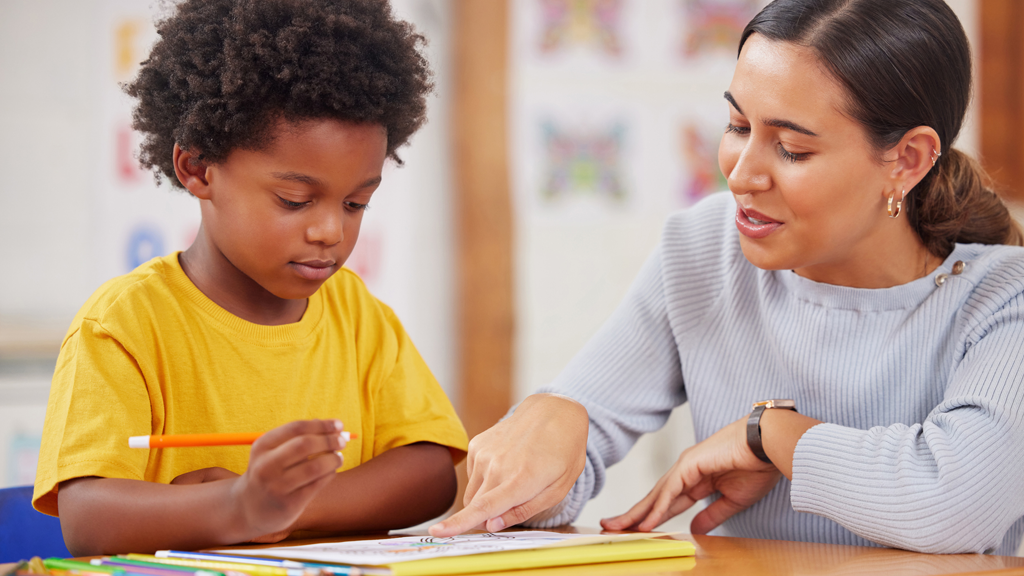 young student working with teacher