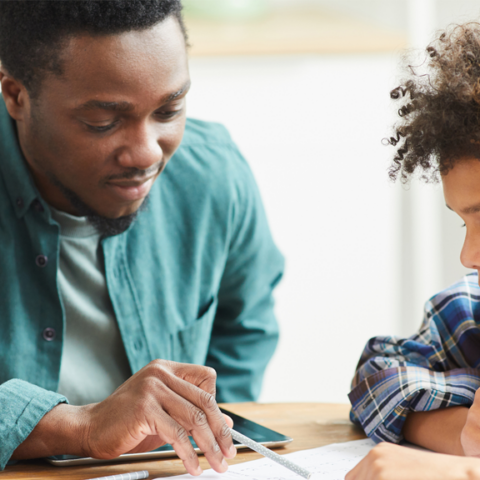 Male teacher helping student