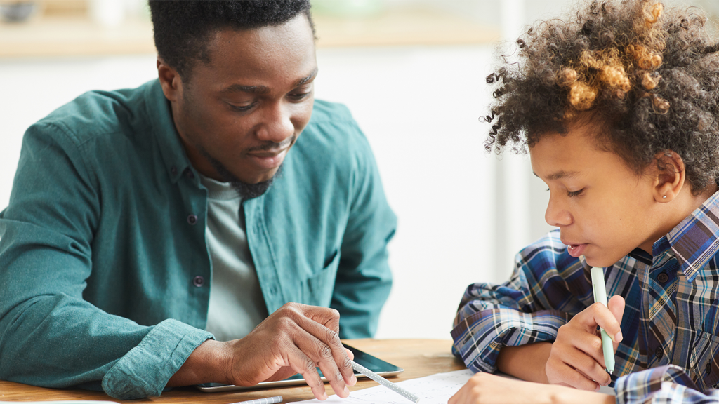 Male teacher helping student