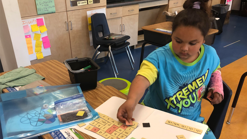 child using manipulatives in classroom