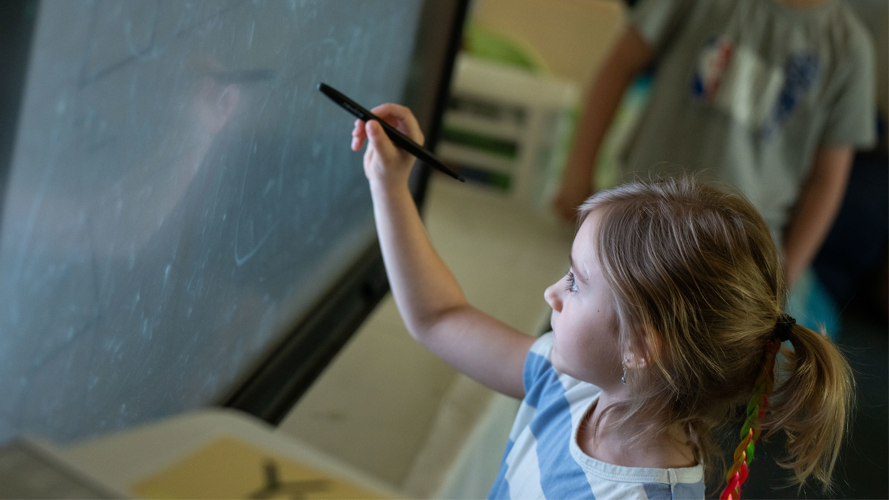 Young girl student at board