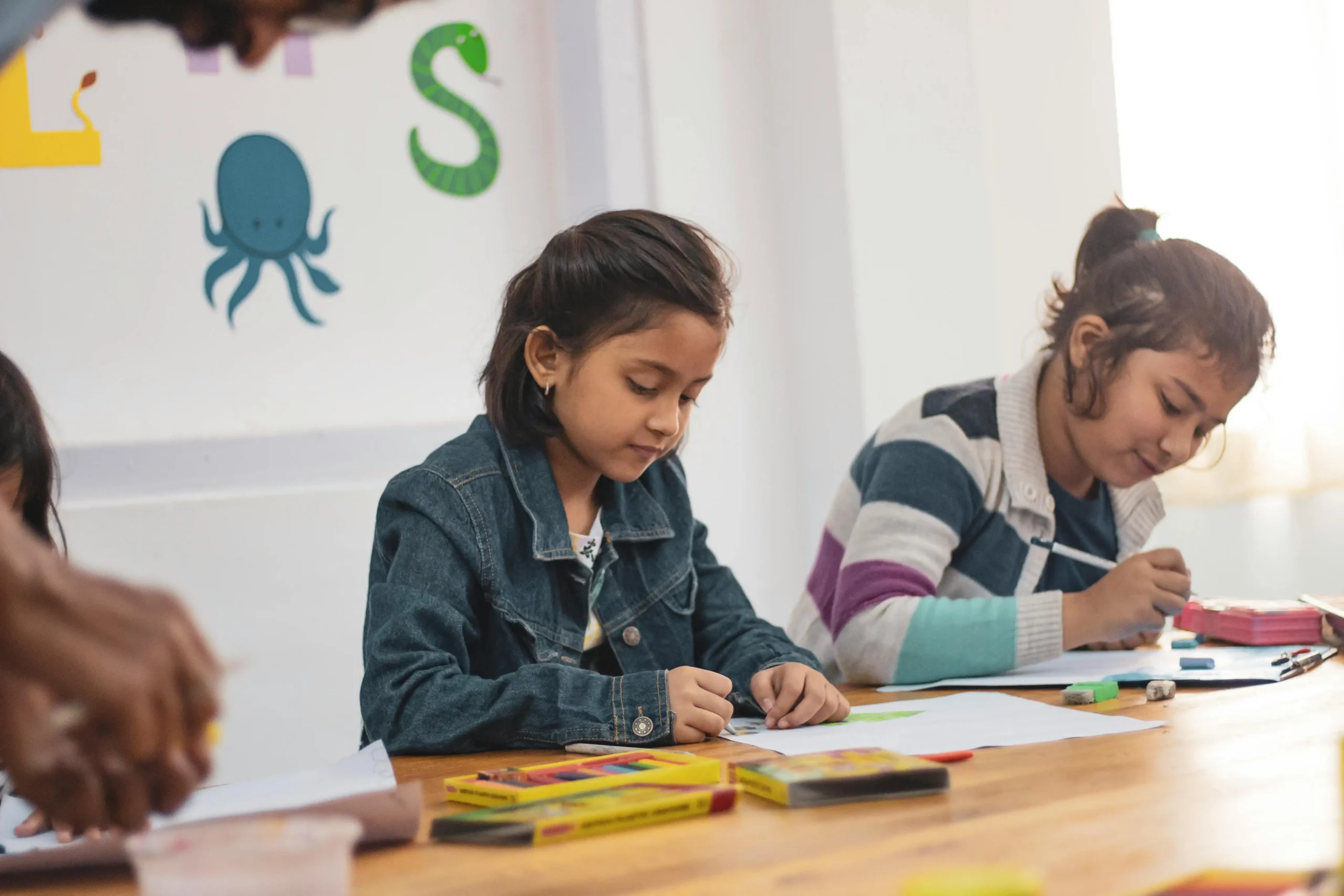Two girls drawing at desk